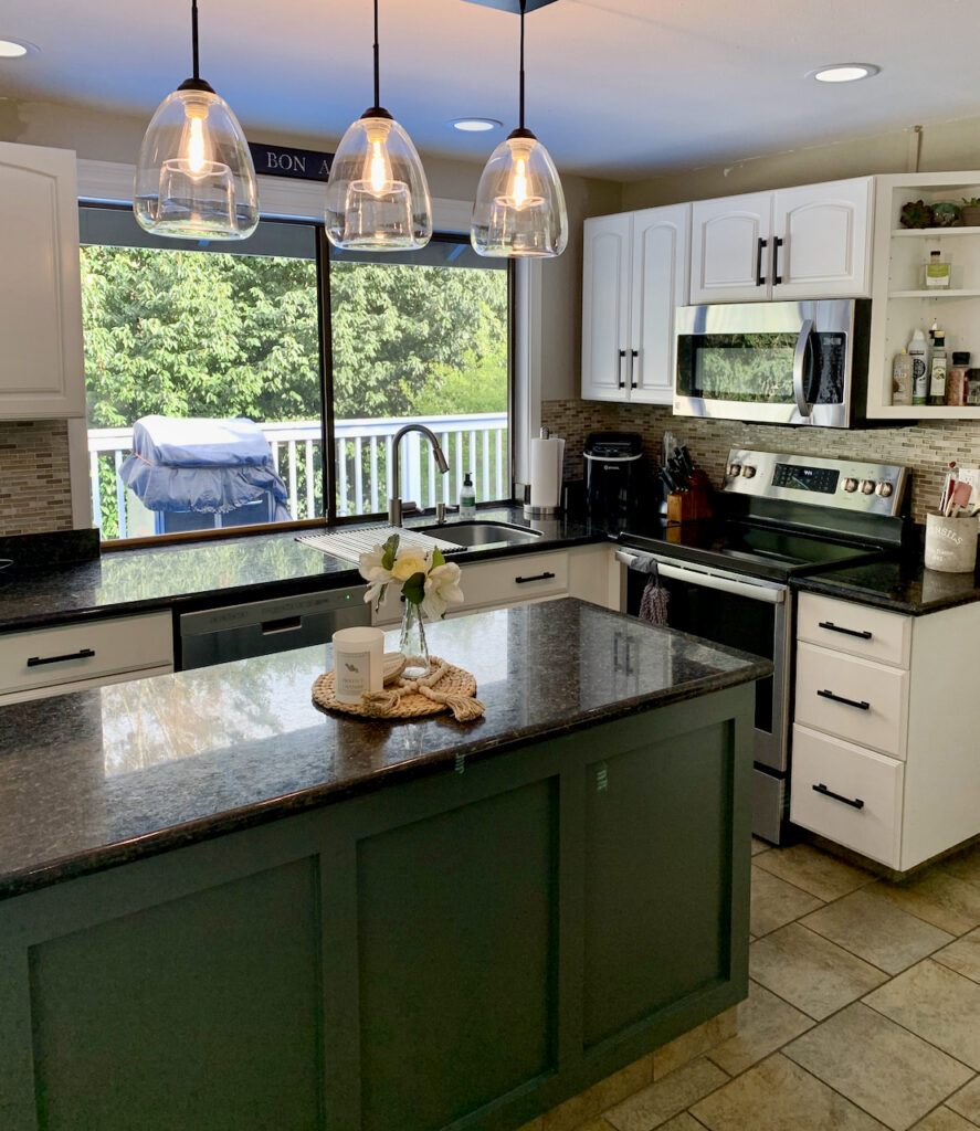 厨房涂上了SW雪花石膏厨柜和SW锡绿色厨房岛。